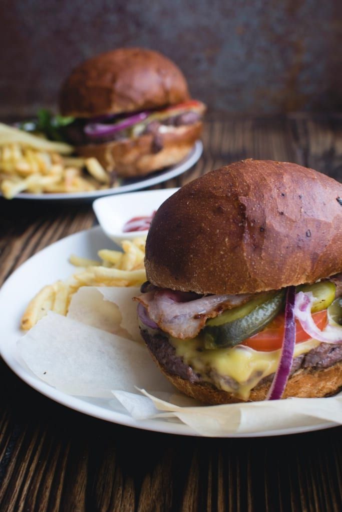 A bacon cheeseburger with fries